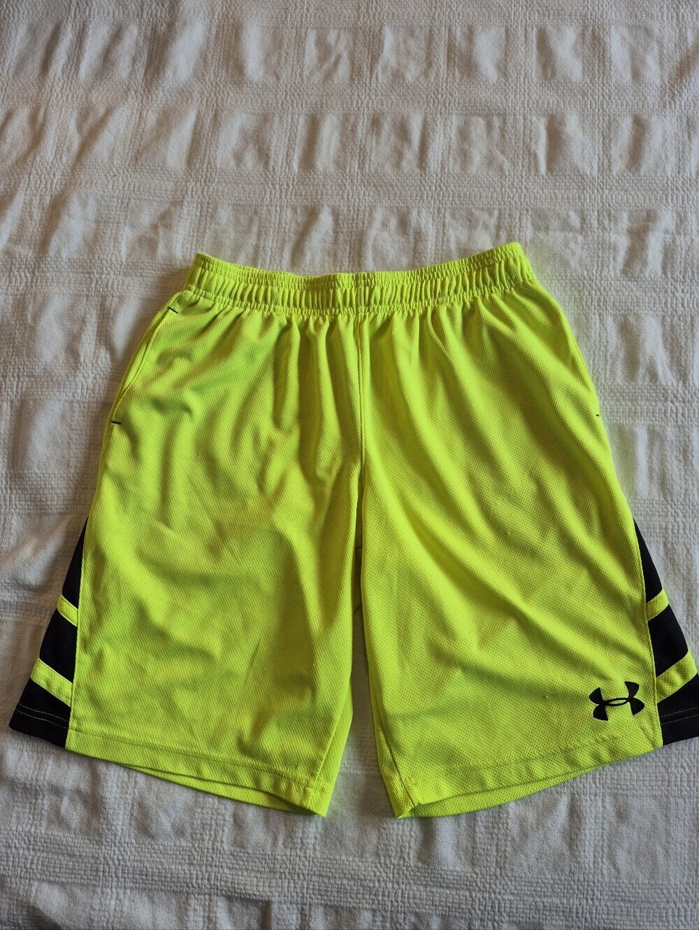 Under Armour boys youth large neon yellow shorts  have a couple defects pulls
